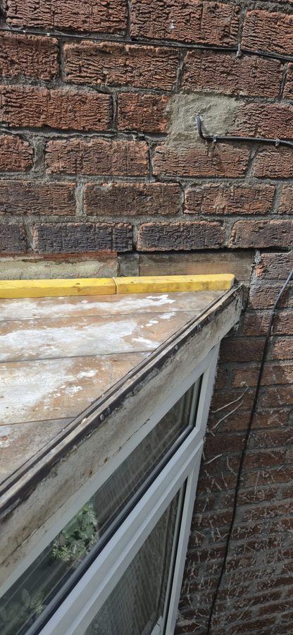 Bay window roof with the old covering stripped back to the timber