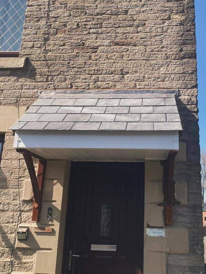 Completed entrance canopy re-slated with new timber brackets and the surrounding stonework made good