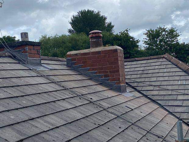 Rebuilt chimney stack with new stepped lead flashings, soakers, flaunching, pot and cowl