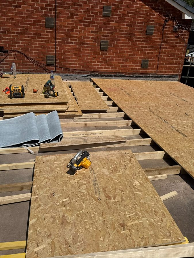 New timber decking laid across the joists of a flat roof
