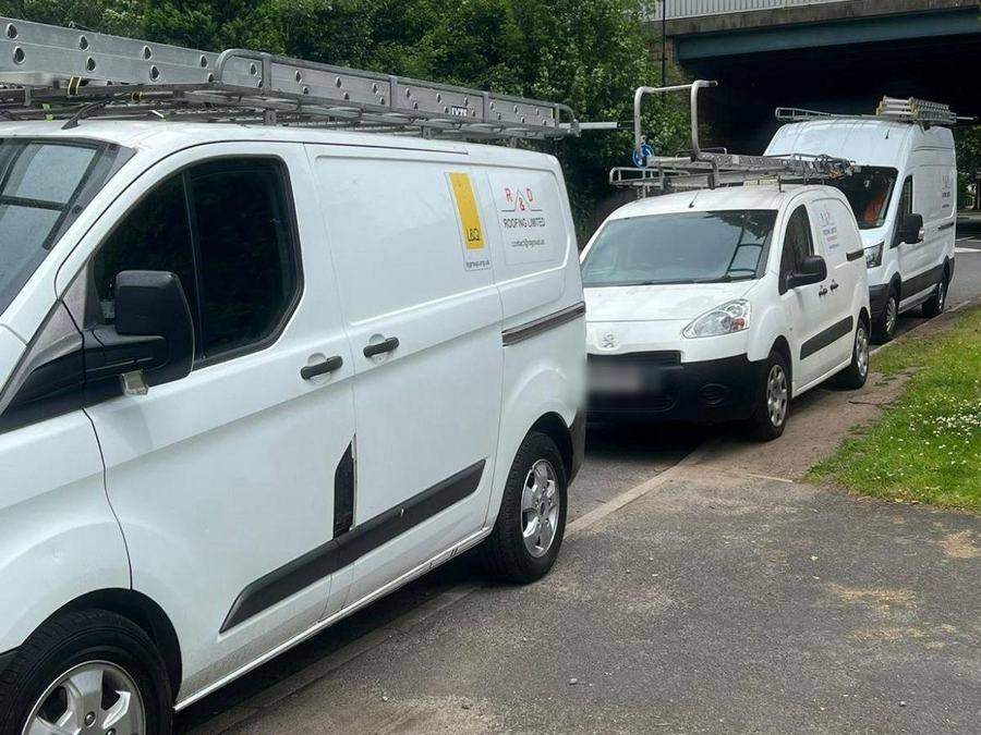 Liveried R&D vans lined up on a verge while working on a contract