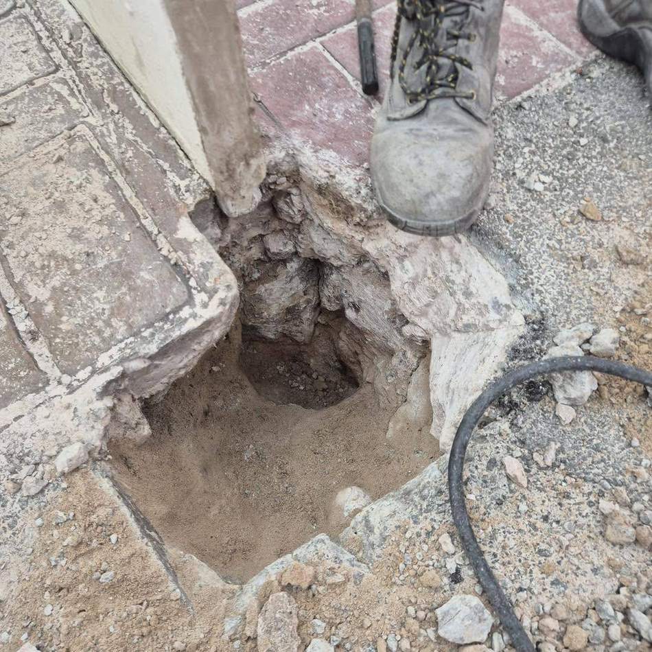 Excavation held open with the existing services located and exposed before the repair