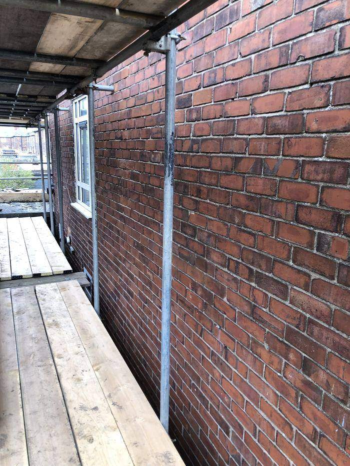 Elevation before repointing, with eroded and cracked mortar joints across the brickwork