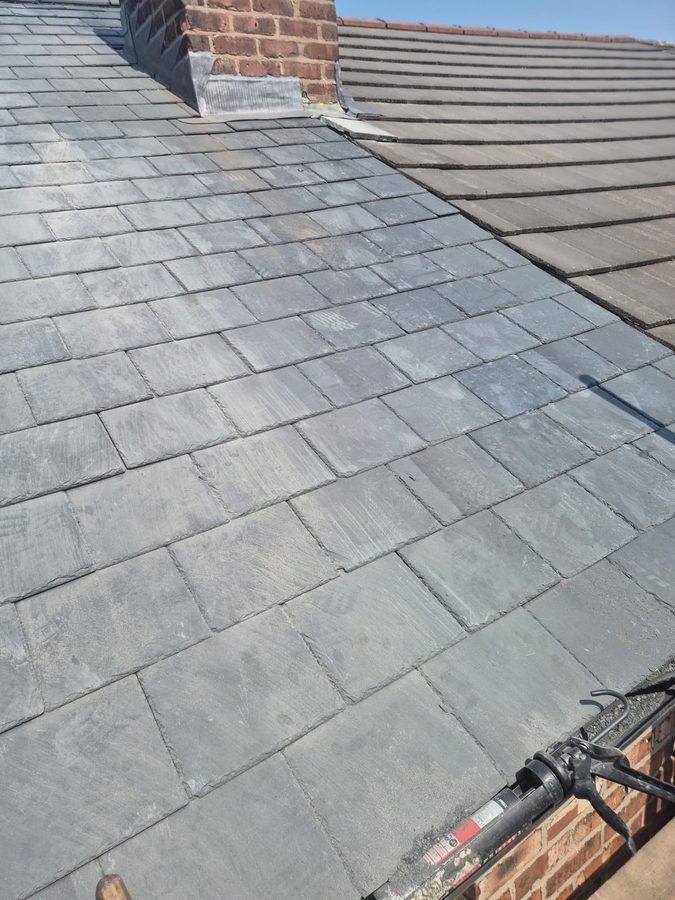 Re-covered roof slope with the chimney stack flashed back in