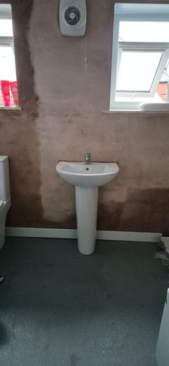 Skimmed bathroom with the basin in and the room ready for second fix