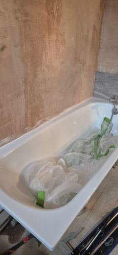 Bathroom walls skimmed around a new bath