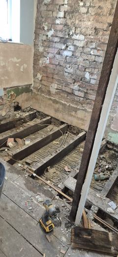 Timber beam exposed where the ceiling has been taken down