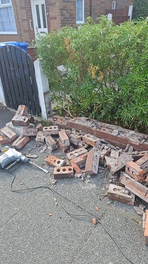 Dwarf boundary wall taken down and the brick stacked for clearing