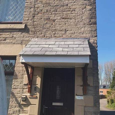 Completed entrance canopy re-slated with new timber brackets and the surrounding stonework made good