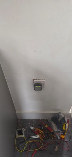 Consumer unit fitted in the corner of a room with test leads below
