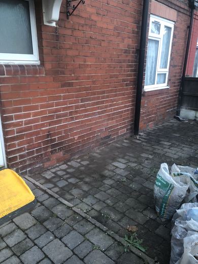 Rear brickwork photographed before repointing, the joints weathered back at low level