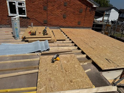New timber decking laid over the joists on a flat roof