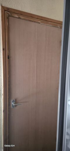 Completed fire doorset with handle, lining and architrave
