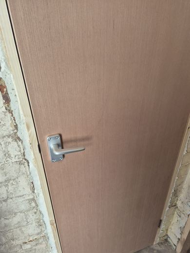Lever handle and latch fitted to a new fire door