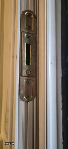 Striking plate let into the frame of a new fire door