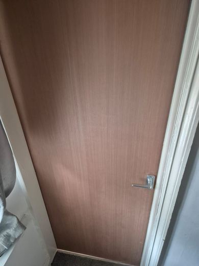 Fire door leaf hung and packed to an even gap in the lining