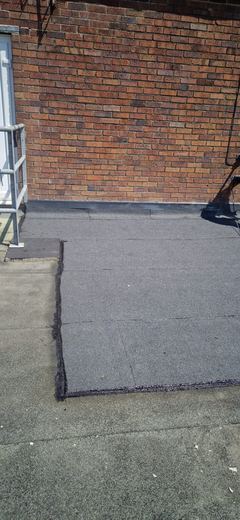 Completed felt flat roof running to the parapet upstand