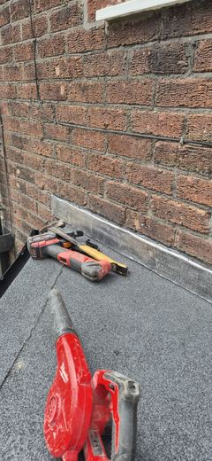 Felt roll and torch on a part-covered flat roof