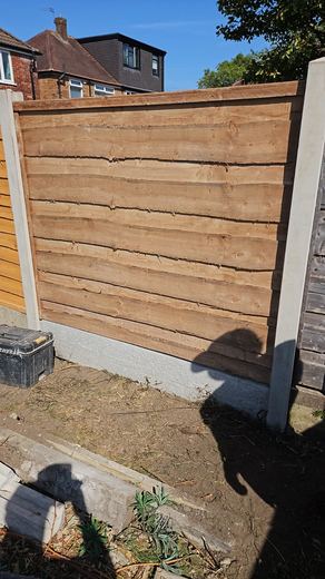 Completed close-board fence in concrete posts and gravel boards