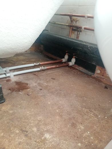 First fix pipework run along the wall of a stripped bathroom