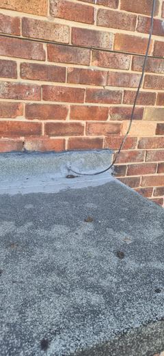 Old flat roof with the chippings cleared back to the covering