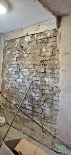 Floor joists and internal brickwork exposed during strip-out
