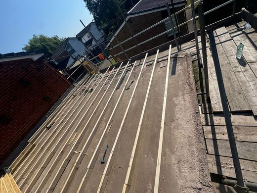 Flat roof stripped back to the joists