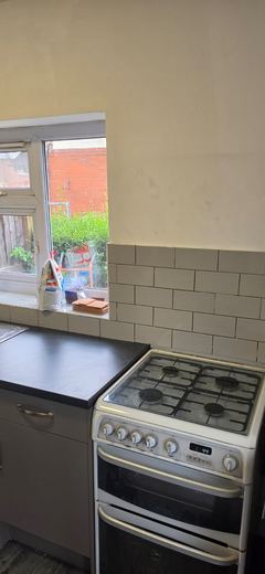 Fitted kitchen with the cooker in place and the window above the sink
