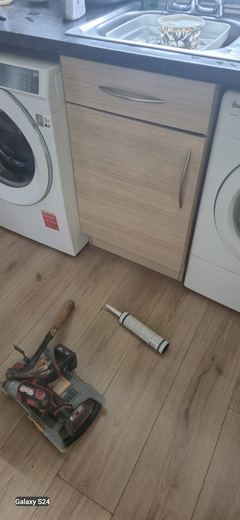 Fitted kitchen run with appliances in place and new flooring down