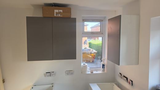 Kitchen wall units fitted either side of the window