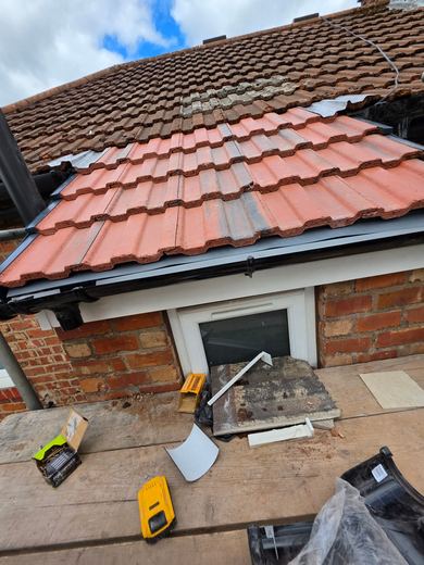 Renewed outrigger roof seen from above with new white fascia and soffit fitted beneath