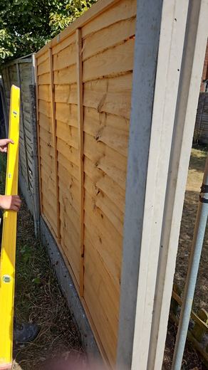 Fence panel checked for level against the post as it is fitted
