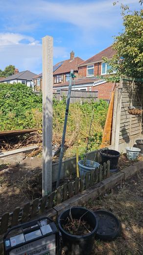Concrete fence posts set in position along a rear boundary