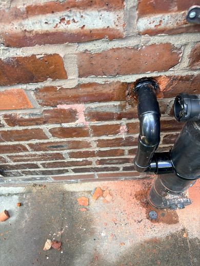 New soil pipe and boss connections fixed back to the brickwork