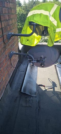 Operative in hi-vis torching on the new covering at the upstand