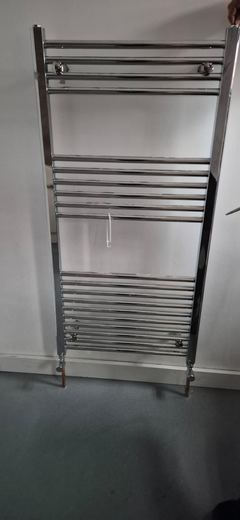 Heated towel rail fitted to a newly finished wall