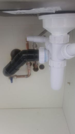 New waste pipework and trap under a kitchen sink