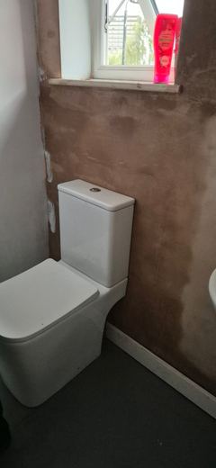New WC and basin fitted in a re-plastered bathroom