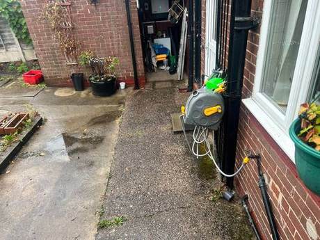 Narrow rear yard and access path kept clear of materials during works