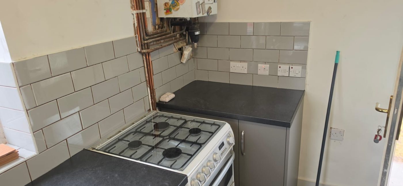 Refurbished void property with a new kitchen fitted, cooker in place and the worktop run complete